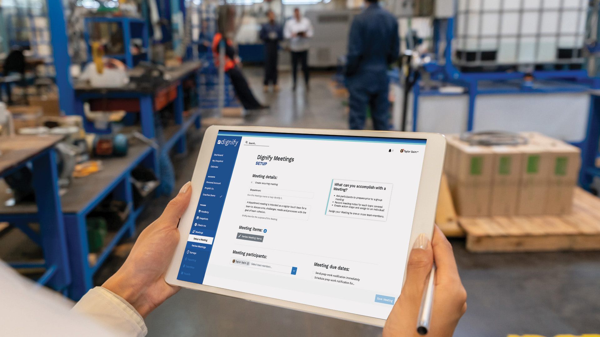 Manufacturing leader holding a tablet setting up a Dignify Meeting